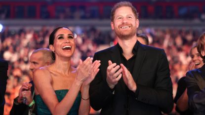 Meghan Markle and Prince Harry clapping and cheering together