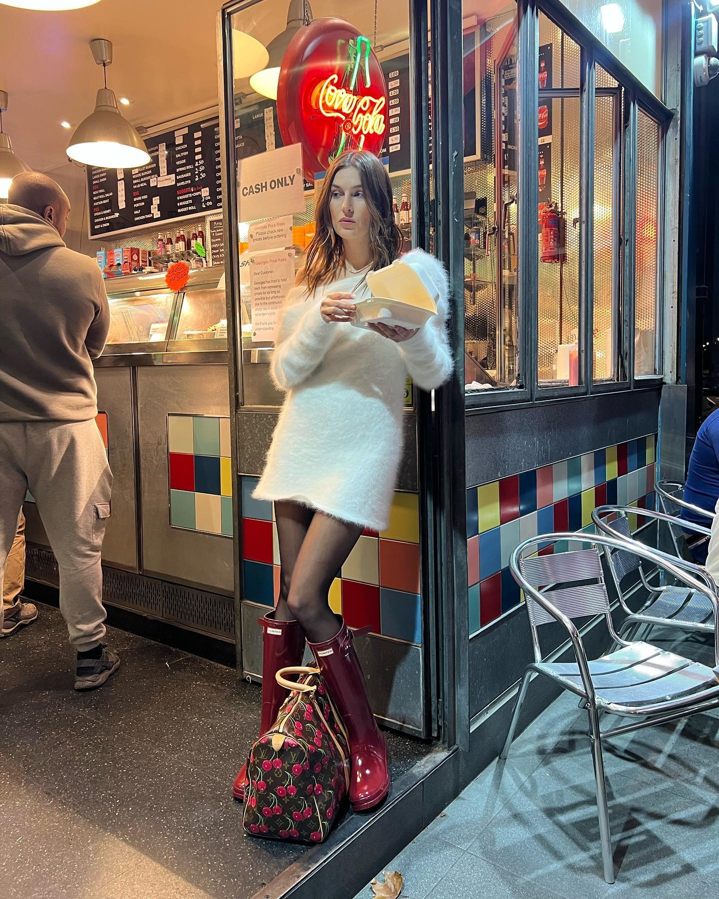 London-based influencer Camille wears bright red hunter rain boots.