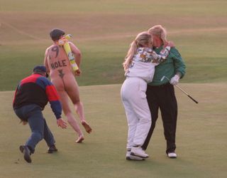 A slight distraction for John Daly at his moment of triumph...