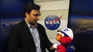Sesame Street's Elmo learns about NASA's new space capsule from SPACE.com's Tariq Malik
