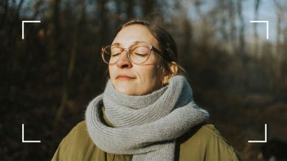 Woman looking up at the sun in winter after learning how to combat sad