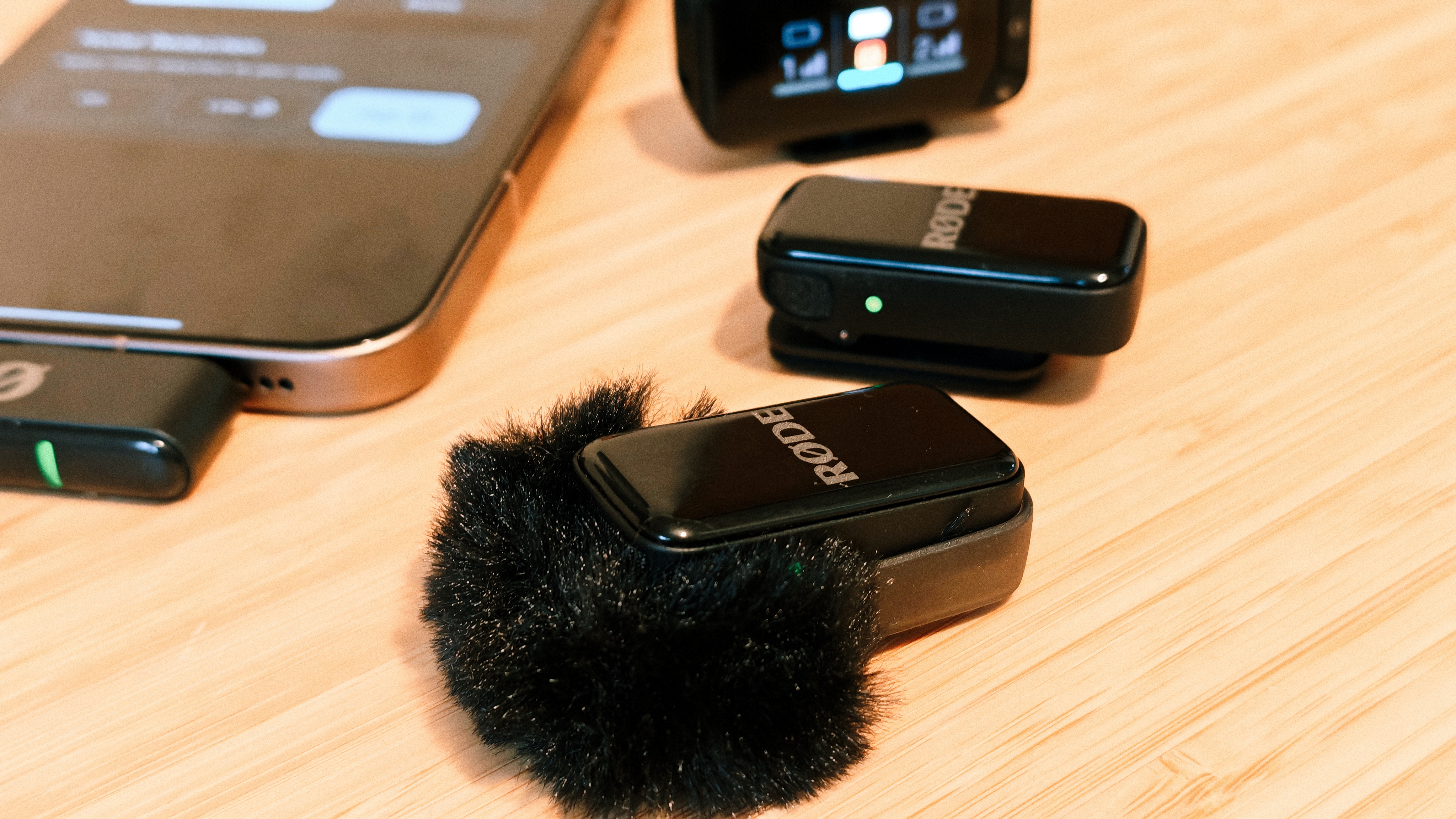 A Rode Wireless Micro Camera Kit on a wooden desk