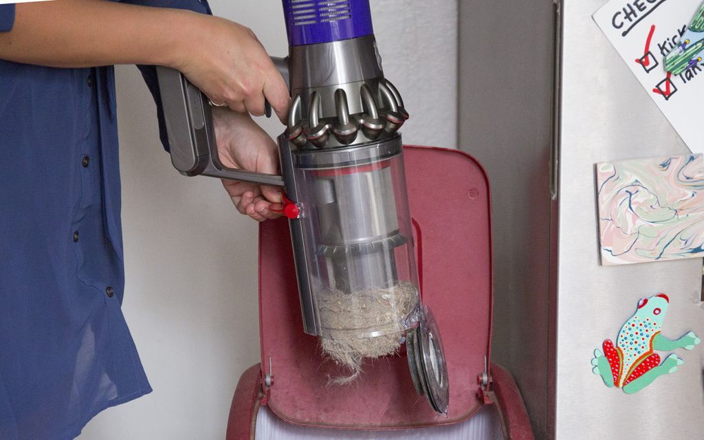 The dust bin on the v10 slides away from you as it opens, so more of the dust ends up in the trash can, not the air.