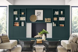 living room with dark green millwork unit with books and objects