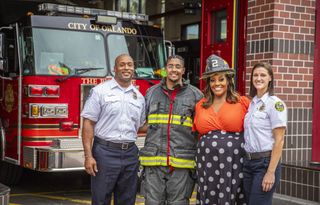 Alison and Aidan Hammond standing in front of red fire engine