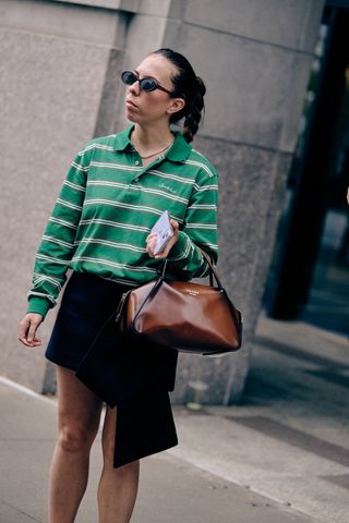 lauren eggertsen at new york fashion week wearing a striped polo and black mini skirt