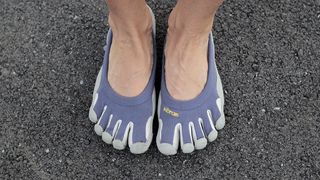 Person's feet wearing Vibram FiveFingers shoes