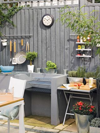 BBQ and gray fence in modern garden