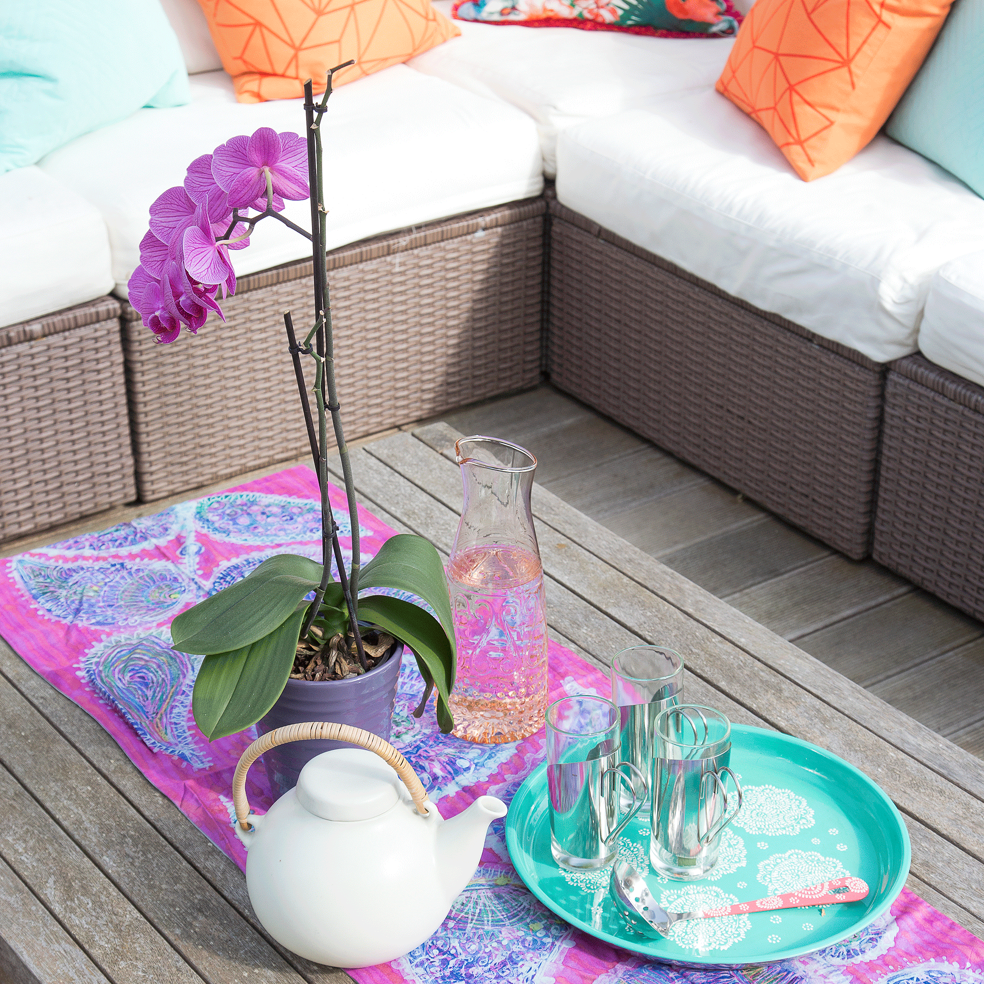 Orchid with purple table runner on coffee table