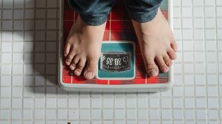 Two feet on weighing scales