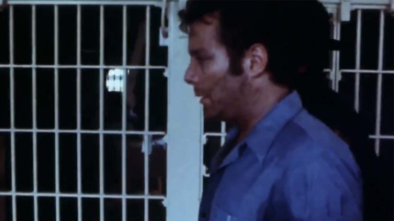 A prisoner walking in front of cells in Faces of Death