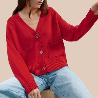 Flat lay image of woman wearing red cardigan