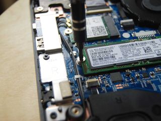 Unscrew the single SSD fastener