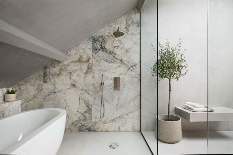a bathroom with a marble shower wall