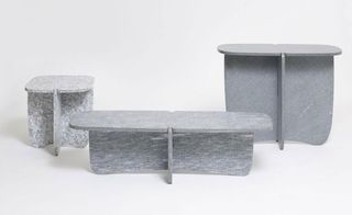 Three tables made of stone in different sizes.