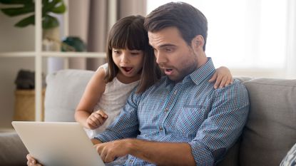 picture of a father and daughter using a laptop computer