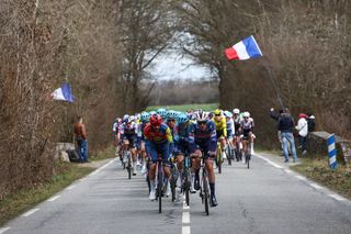 The pack of riders cycles during the 1st stage of the Paris-Nice cycling race, 156,1 km between Le Perray-en-Yvelines and Le Perray-en-Yvelines, on March 9, 2025. (Photo by Anne-Christine POUJOULAT / AFP)