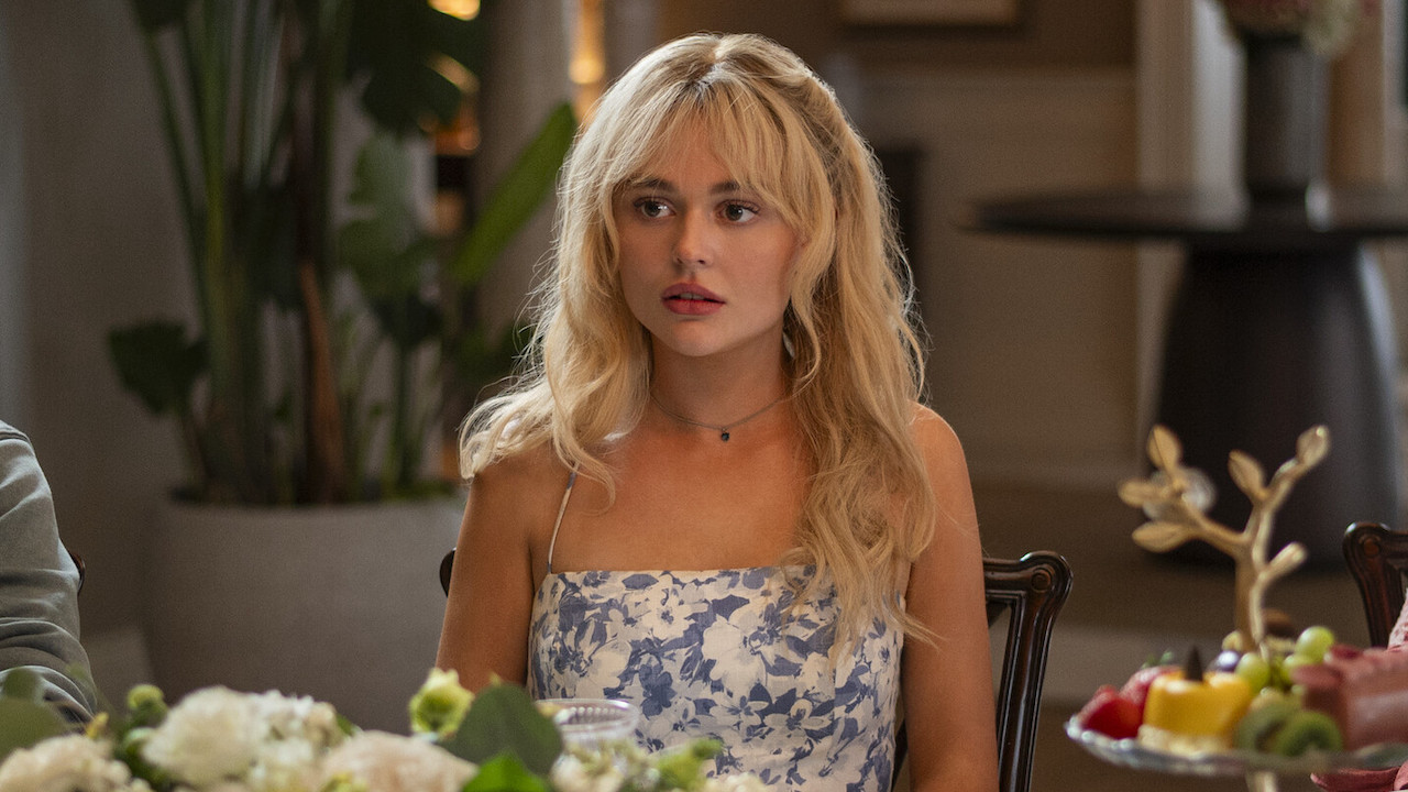 Emily Alyn Lind at the table as Cadence in We Were Liars
