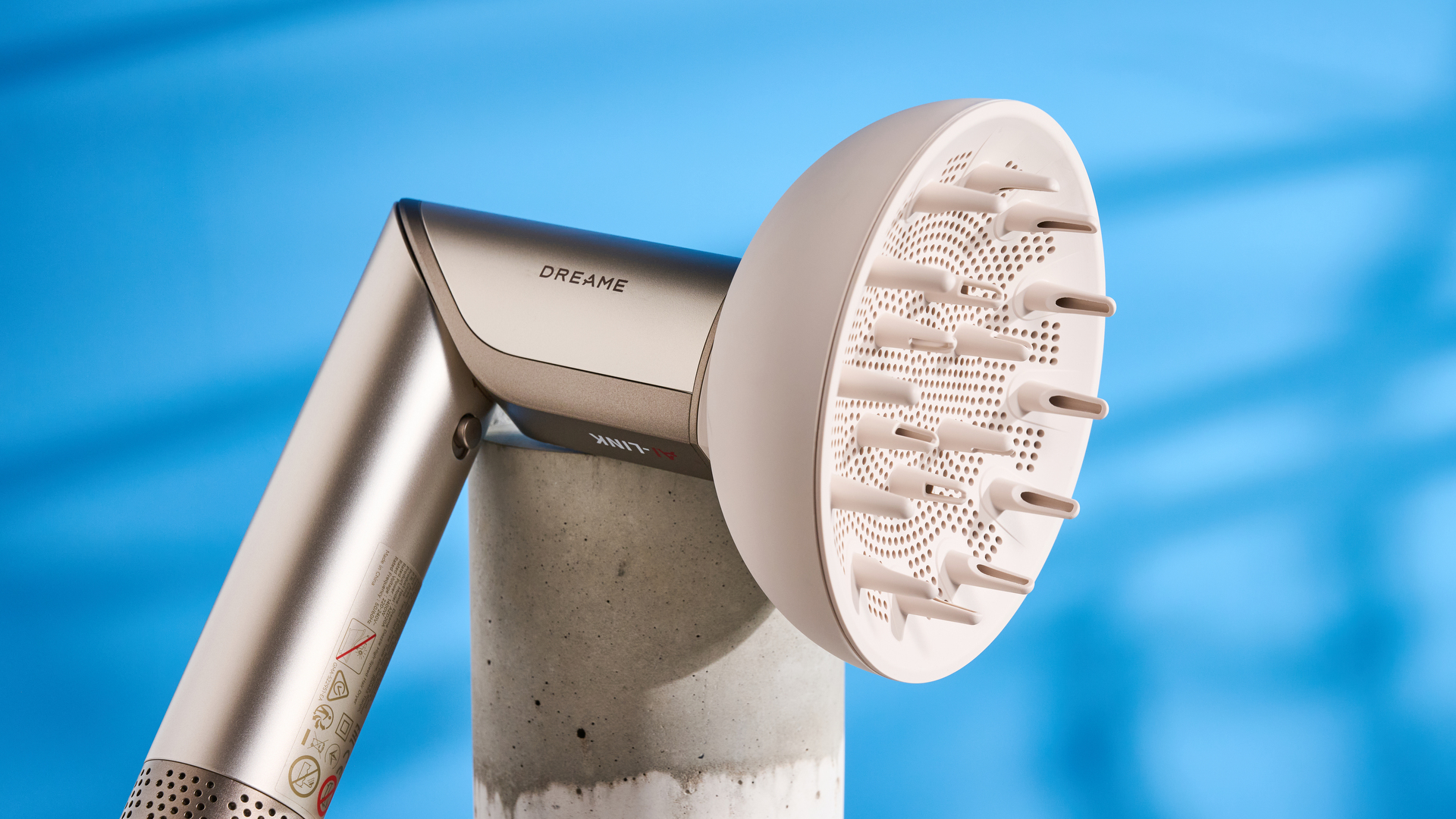 Dreame Dazzle air styler photographed in front of a blue background