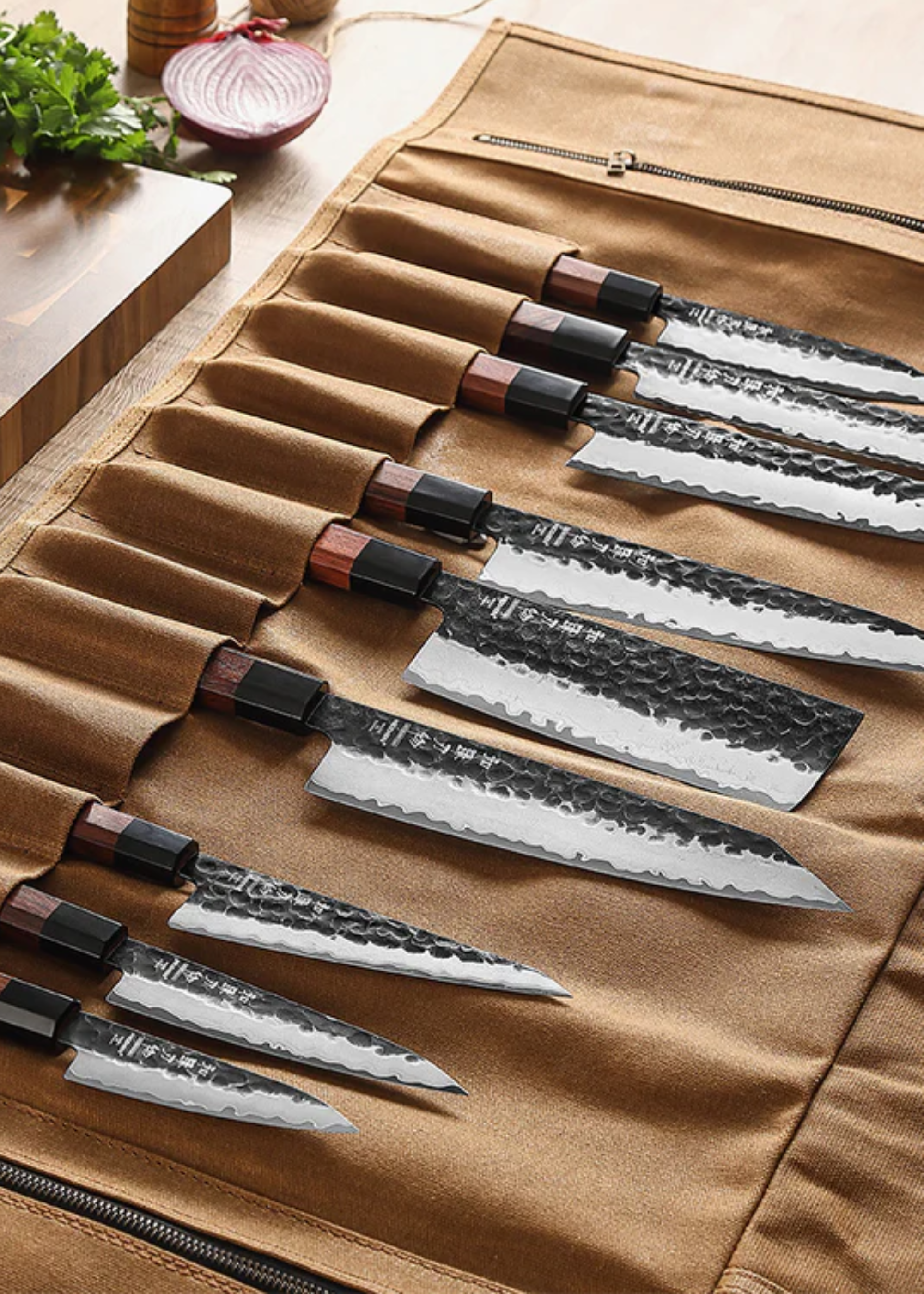 A Hezhen knife roll with knives on top of a kitchen counter