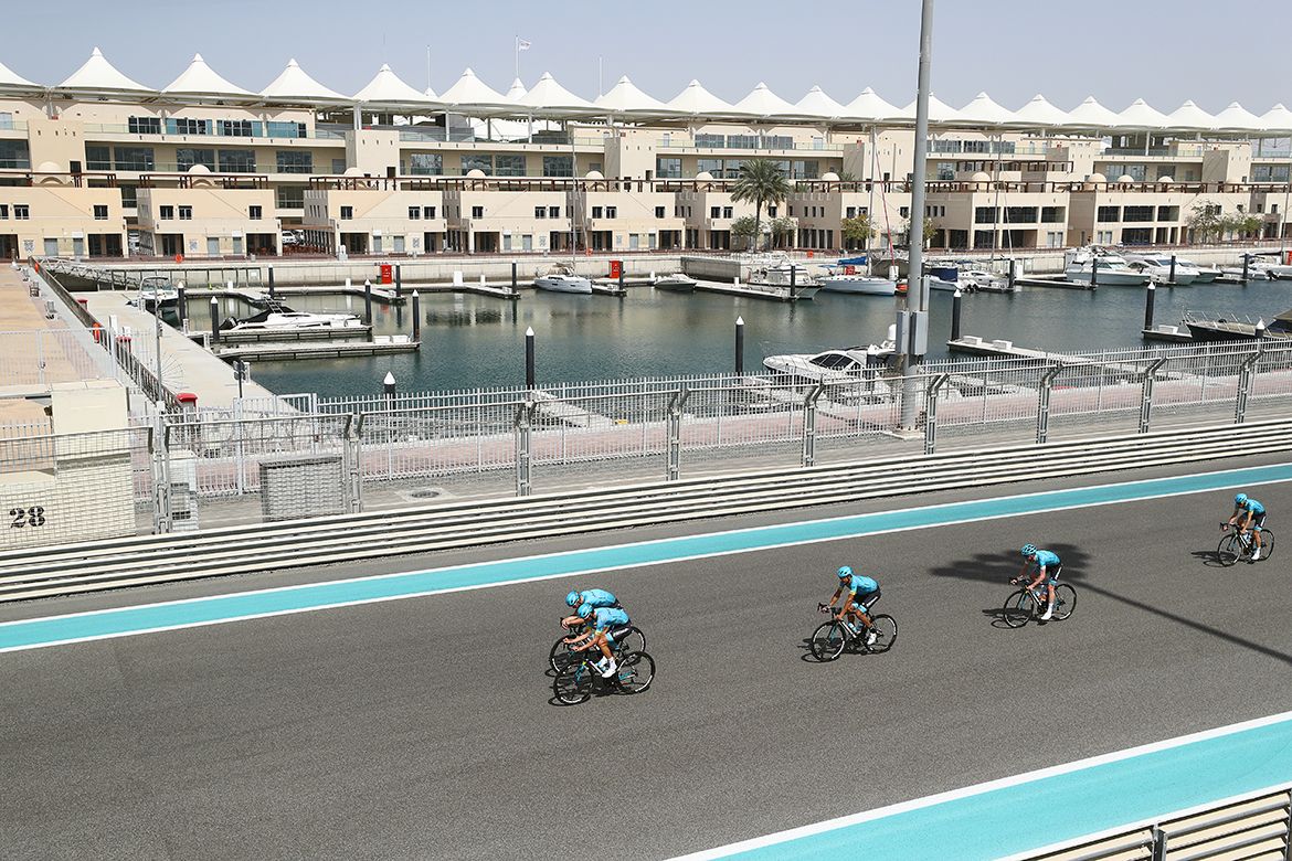 Astana riders pedal past the Yas Marina