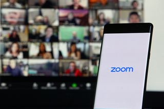Zoom displayed on a laptop and smartphone