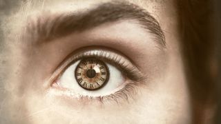 Clock inside a person's brown iris in their eye.