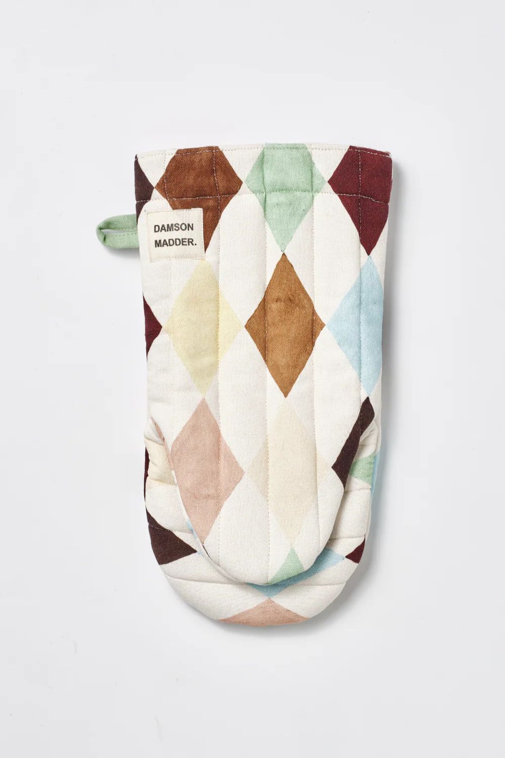 White oven glove with brown, blue and cream harlequin pattern