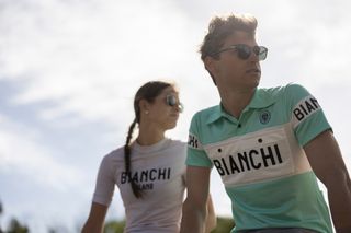 A male and female cyclist wear jerseys from Bianchi's new Milano collection