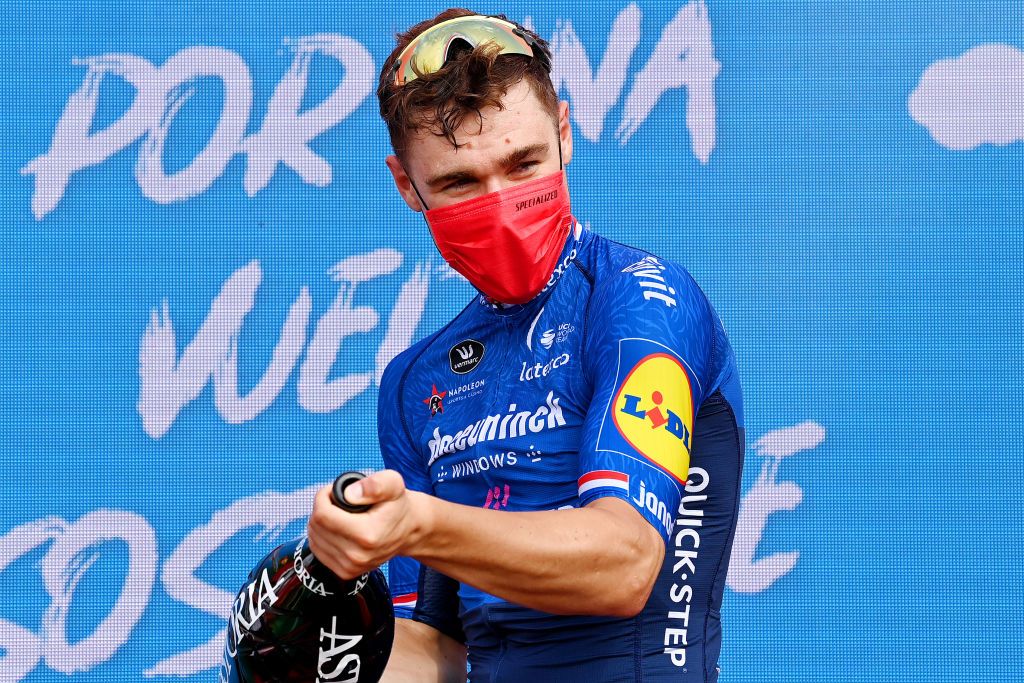 LA MANGA SPAIN AUGUST 21 Fabio Jakobsen of Netherlands and Team Deceuninck QuickStep celebrates winning the stage on the podium ceremony after during the 76th Tour of Spain 2021 Stage 8 a 1737 km stage from Santa Pola to La Manga del Mar Menor lavuelta LaVuelta21 on August 21 2021 in La Manga Spain Photo by Stuart FranklinGetty Images