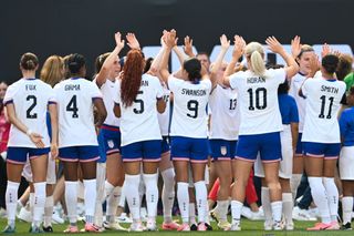 United States women Olympics 2024 squad Sophia Smith #11, Lindsey Horan #10, Mallory Swanson #9, Trinity Rodman #5, Naomi Girma #4, and Emily Fox #2 of the United States high five teammates before a game between Mexico and USWNT at Red Bull Arena on July 13, 2024 in Harrison, New Jersey. (Photo by Stephen Nadler/ISI Photos/USSF/Getty Images for USSF)