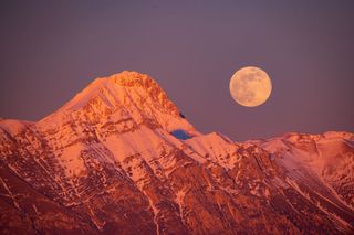 Wolf moon rising next to Corno Grande and Pizzo Cefalone peaks (Gran Sasso d'Italia National Park) is seen from Tornimparte (L'Aquila), Italy, on January 25th, 2024.