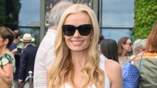 Katherine Jenkins is pictured wearing a white dress and sunglasses during day two of the 2026 Wimbledon Tennis Championships at the All England Lawn Tennis and Croquet Club on June 30, 2026 in London, England. 
