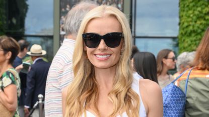 Katherine Jenkins is pictured wearing a white dress and sunglasses during day two of the 2026 Wimbledon Tennis Championships at the All England Lawn Tennis and Croquet Club on June 30, 2026 in London, England.