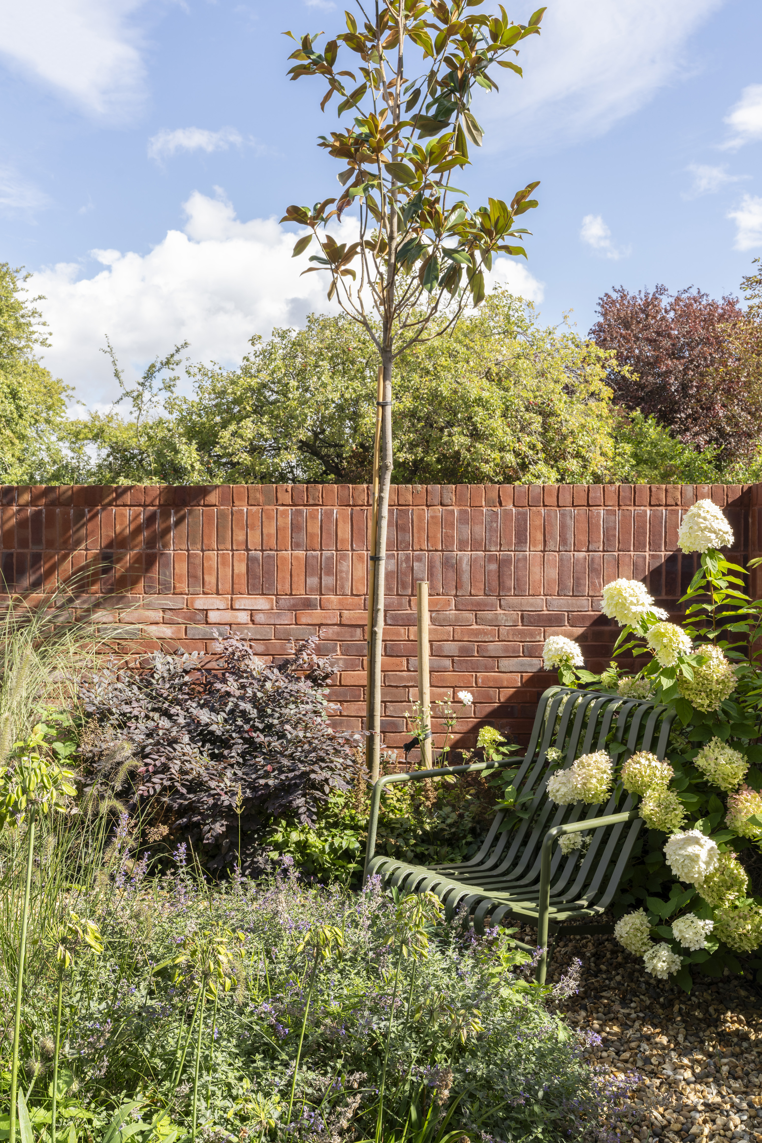view of interiors of Coeus London - Serene, a brick residential structure with a lush garden