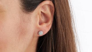A woman's ear wearing a Goldsmith's diamond stud earring