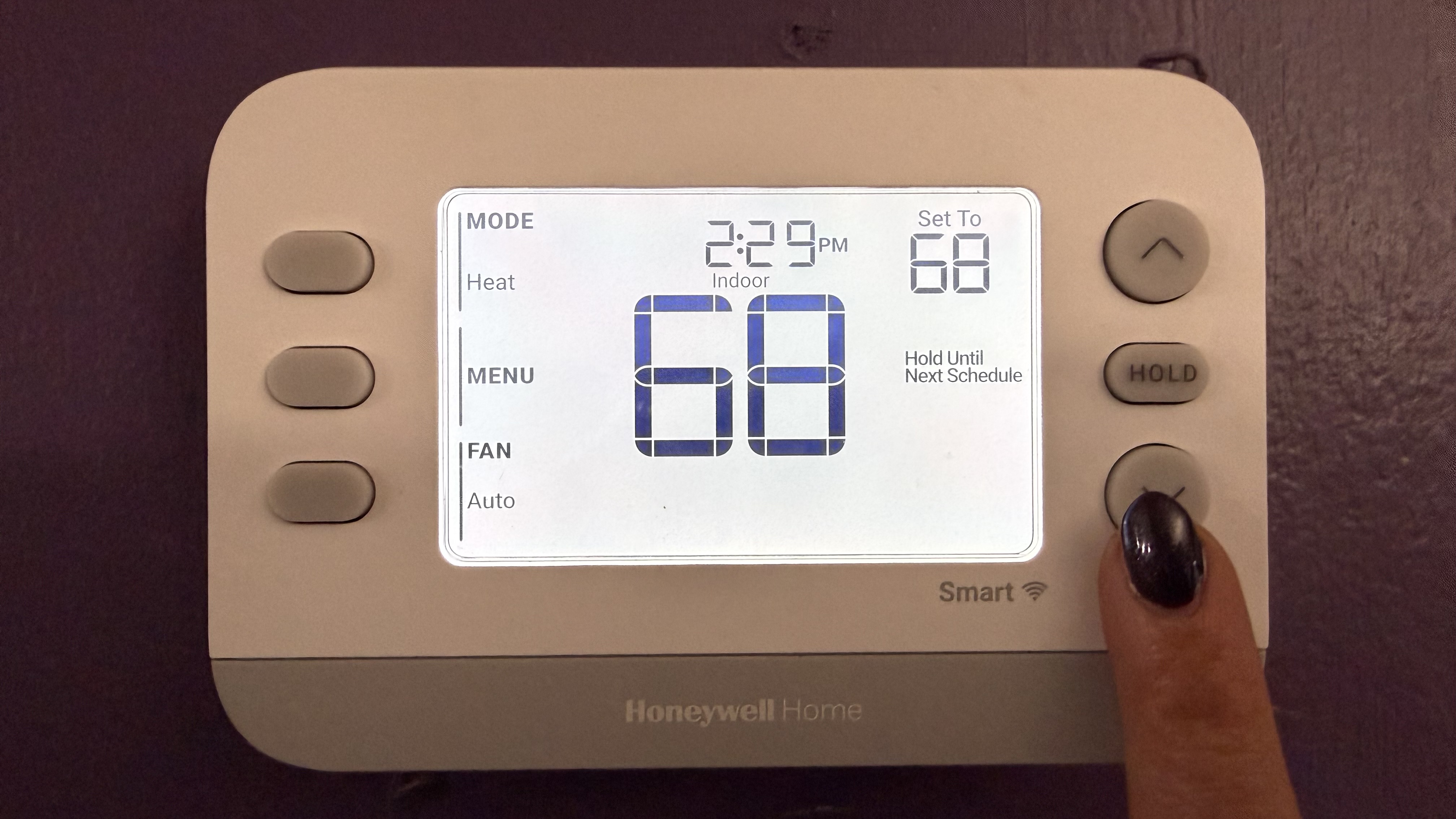 Honeywell Home X2S Smart Thermostat finger on controls