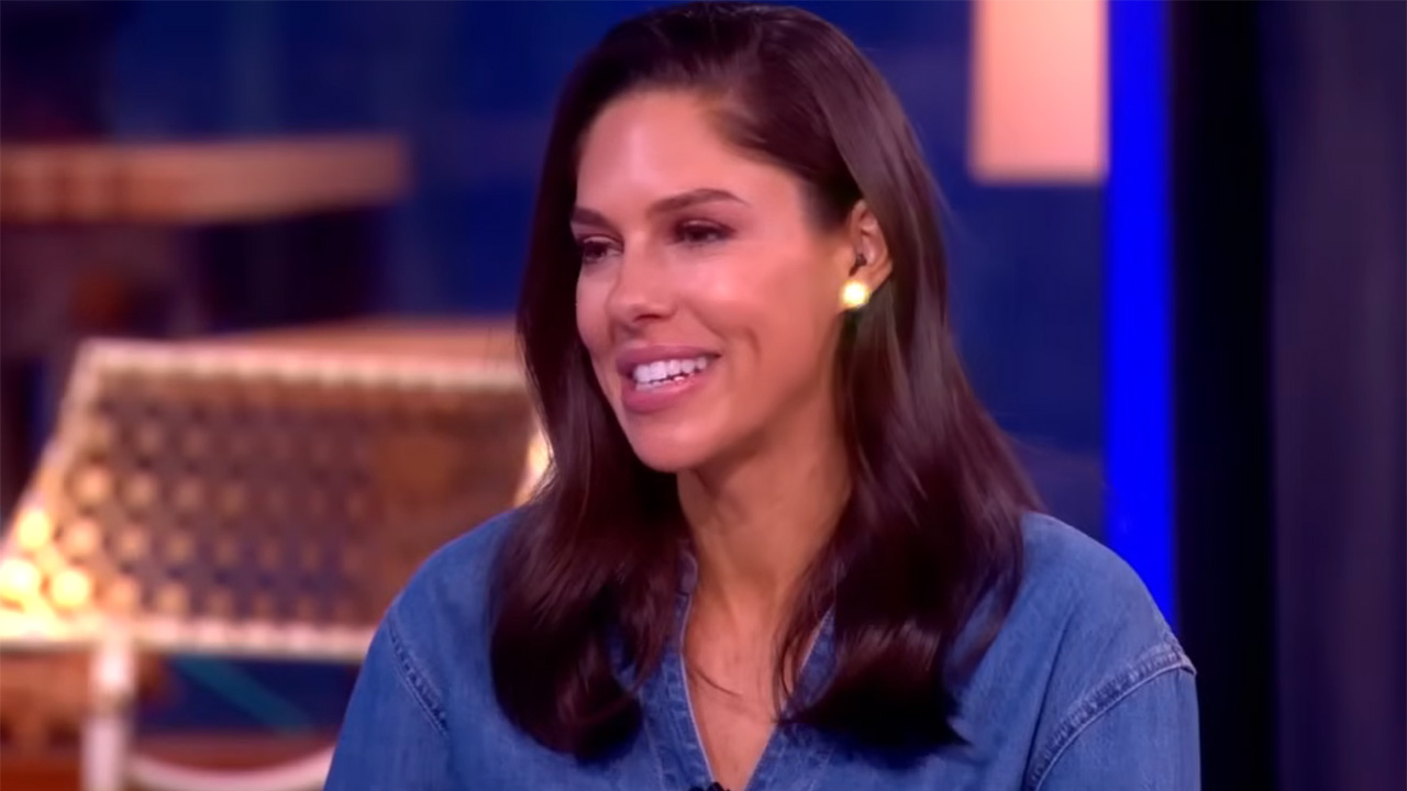 Abby Huntsman in stud earrings and a blue top sitting at the Hot Topics table on The View.