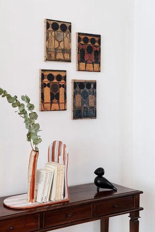 canopy-collections-wooden-console-with-sculptures-and-wall-art