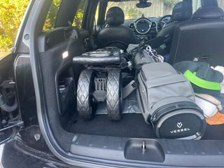 The BagBoy slimfold push cart folded down in the boot of a car