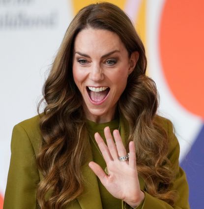 Kate Middleton wearing an olive green suit and waving