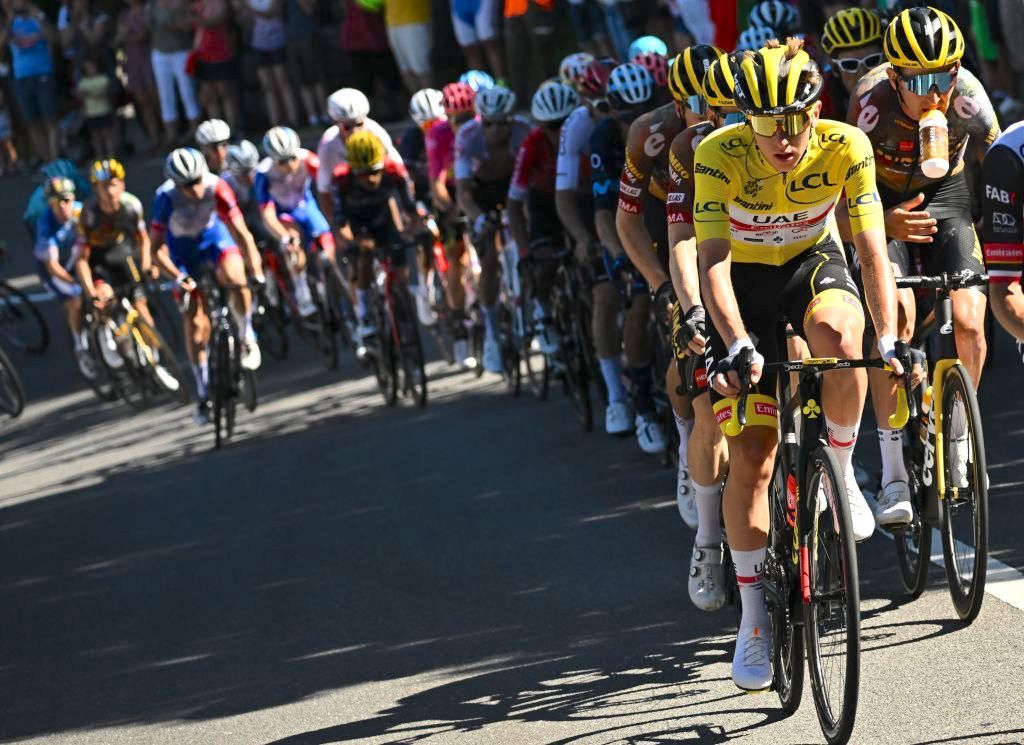 UAE Team Emirates team's Slovenian rider Tadej Pogacar wearing the overall leader's yellow jersey cycles with the pack of riders during the 9th stage of the 109th edition of the of the Tour de France cycling race, 192,9 km between Aigle in Switzerland and Chatel Les Portes du Soleil in the French Alps, on July 10, 2022. (Photo by Anne-Christine POUJOULAT / AFP) (Photo by ANNE-CHRISTINE POUJOULAT/AFP via Getty Images)