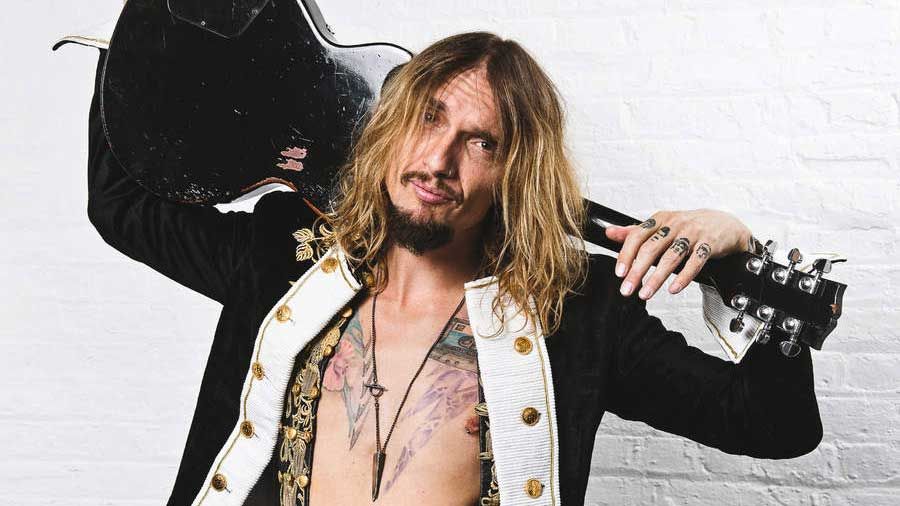 Justin Hawkins holding a guitar