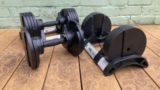 Core Home Fitness Adjustable Dumbbells next to cradle