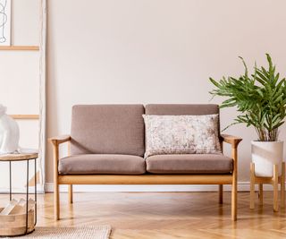 a simple loveseat on wooden floor