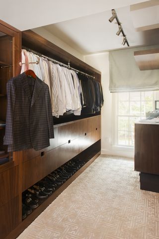Dressing room with dark walnut cabinetry