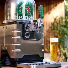 A Beerwulf tap next to a freshly pulled pint of Heineken beer