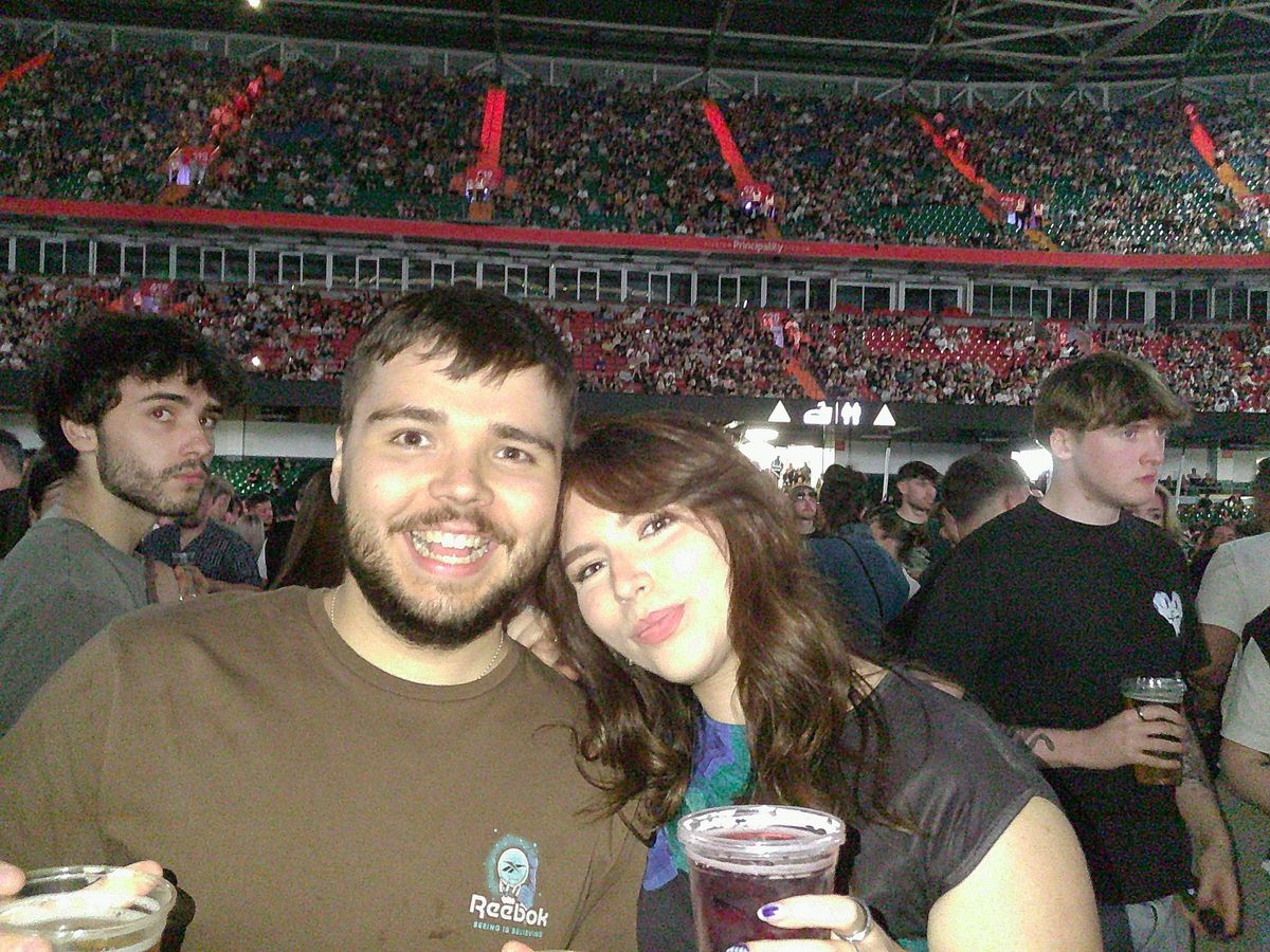 Image of man and woman in stadium holding drinks taken with the Camp Snap Screen-Free Digital Camera.