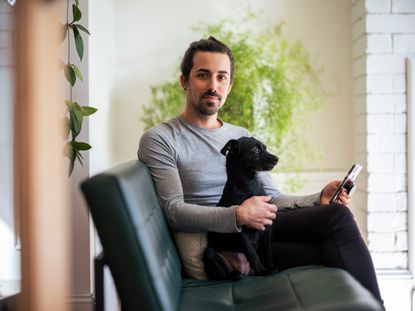 Jo Lemos with dog and HiveHome app on phone