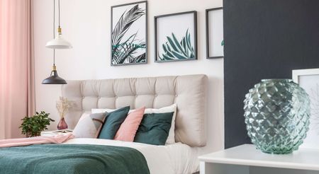 Pink, white and green bedding in a white bedroom